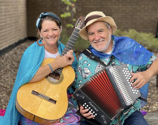 Woman with guitar and man with accordian.